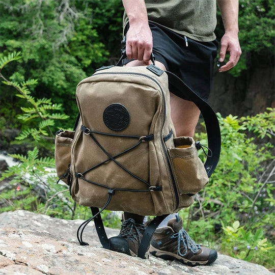 Woodsmans Pack Backpack Lake Ontario Black Trim and Wax Khaki Held by Man