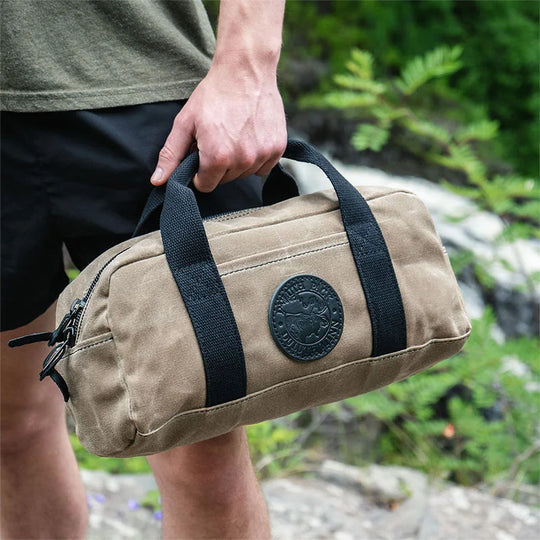 Lake Ontario Utility Bag Black Trim and Waxed Khaki Held by Man