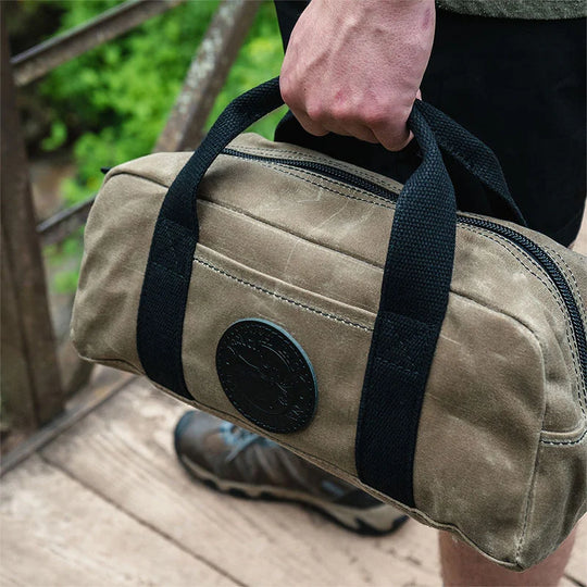 Lake Ontario Utility Bag Black Trim and Waxed Khaki Held by Man